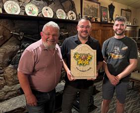 A group of men holding a plaque

AI-generated content may be incorrect.